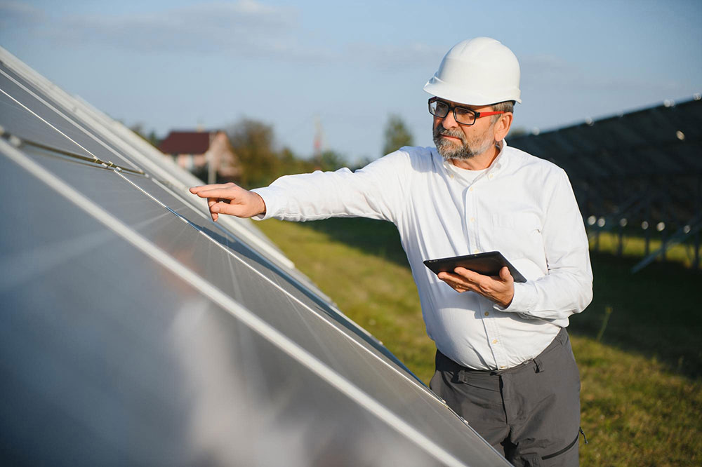 tulsa-roof-replacement-guide-costs-materials-and-what-to-expect-in-2026 Roof Replacement contractor inspecting residential roof panels with a tablet in Tulsa