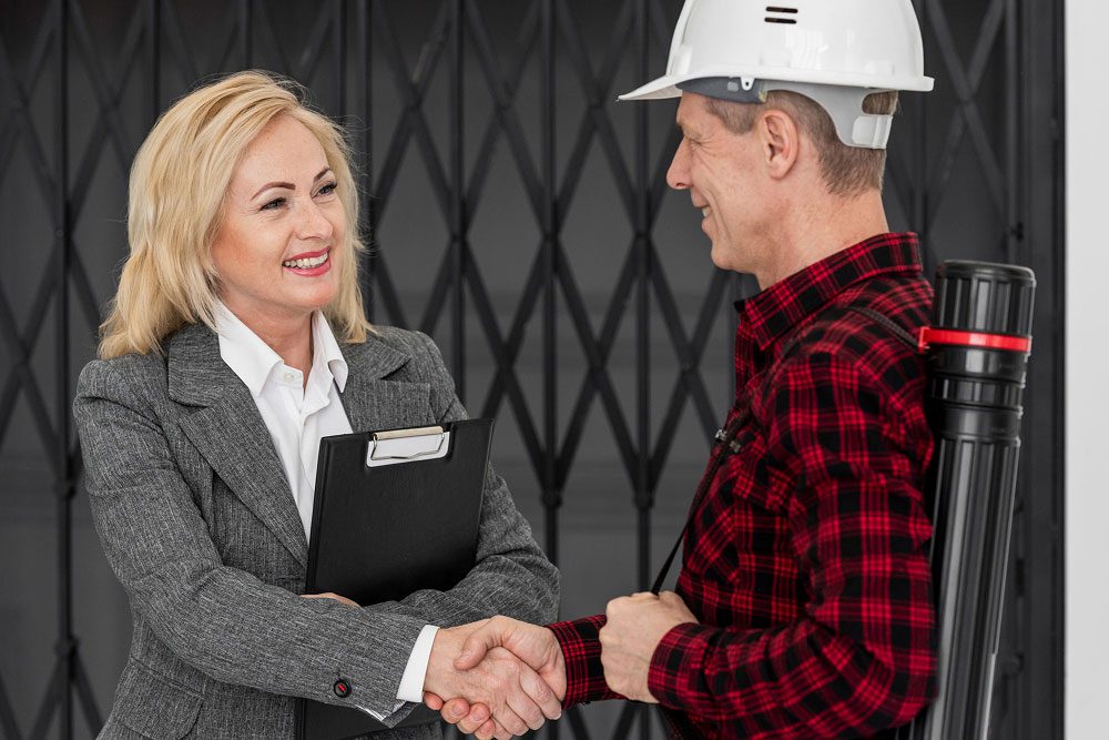 Top-Commercial-Roofing-Contractors-in-OKC_-How-to-Choose-the-Right-Partner-for-Your-Business-1 (1) Commercial Roofing Contractors in OKC meeting with business owner and shaking hands to discuss roofing project partnership