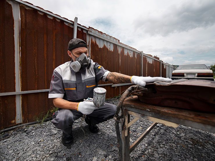leaks-and-damage Technician performing a commercial roof inspection to check for leaks and roof damage